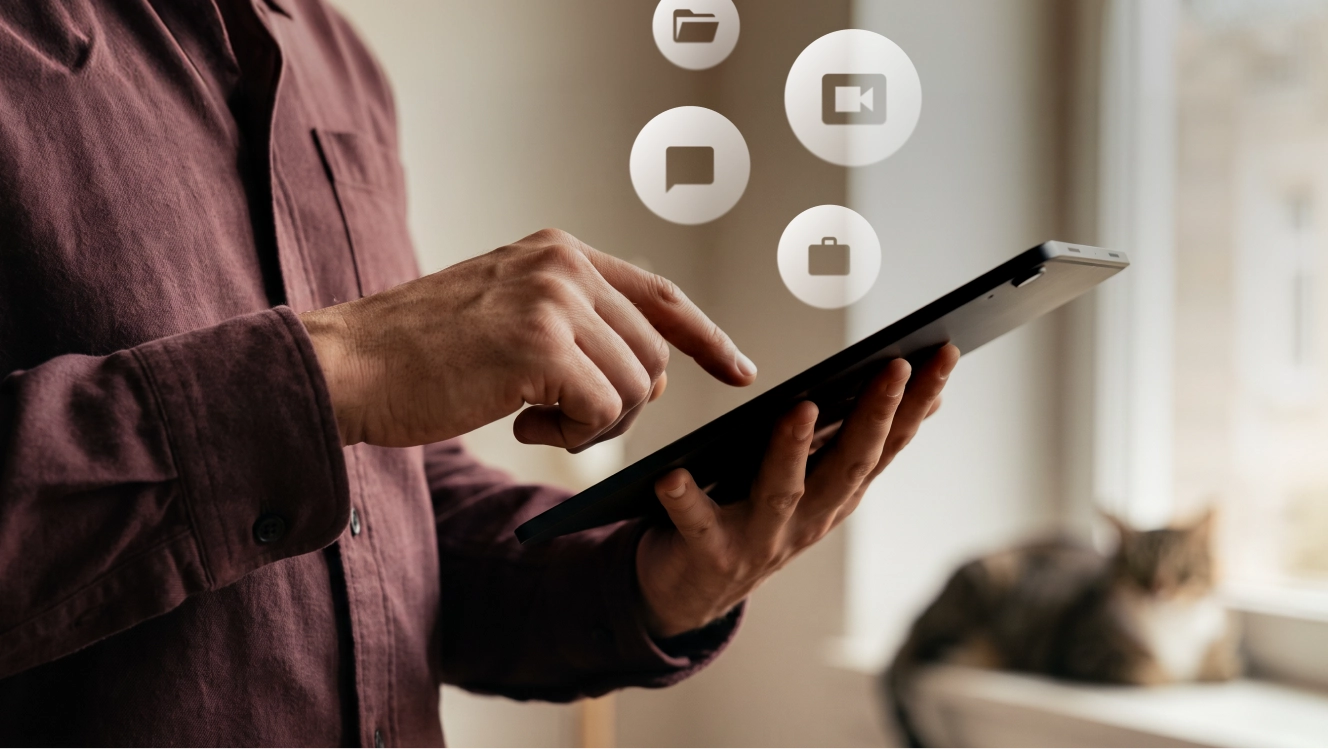 A remote worker tapping a tablet with communication, video, and task tool icons floating above it